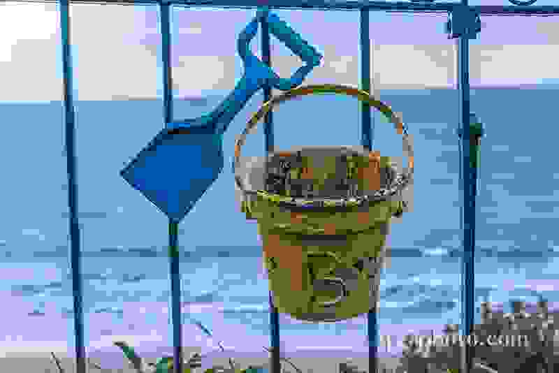 Metal ornament on a balustrade in a seaside village, a symbolic 
