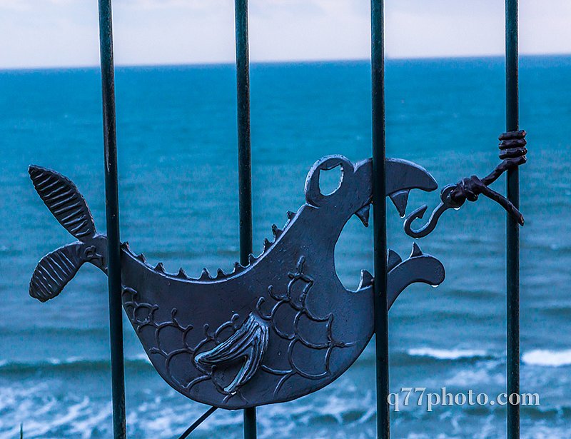 metal ornament on a balustrade in a seaside village, symbolic in
