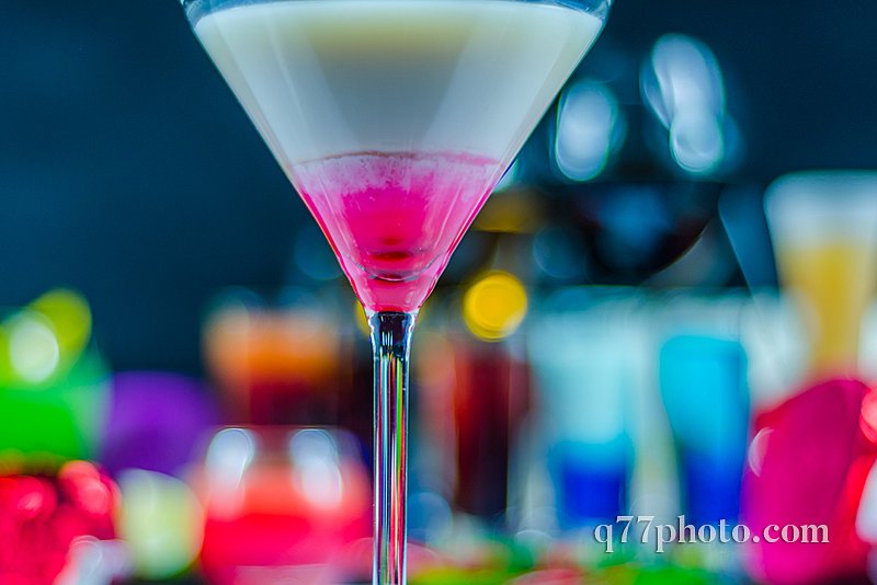 colored drink in a martini glass, a combination of white with pi
