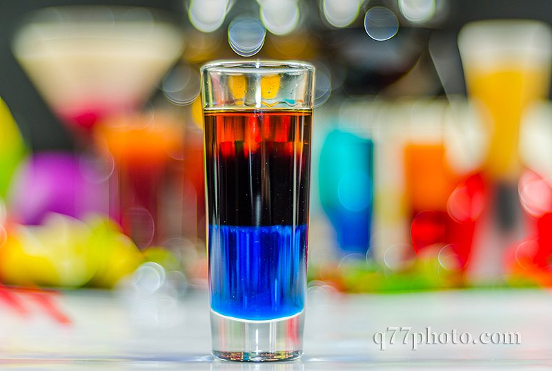 colored drink in glass for shots, a combination of blue with red