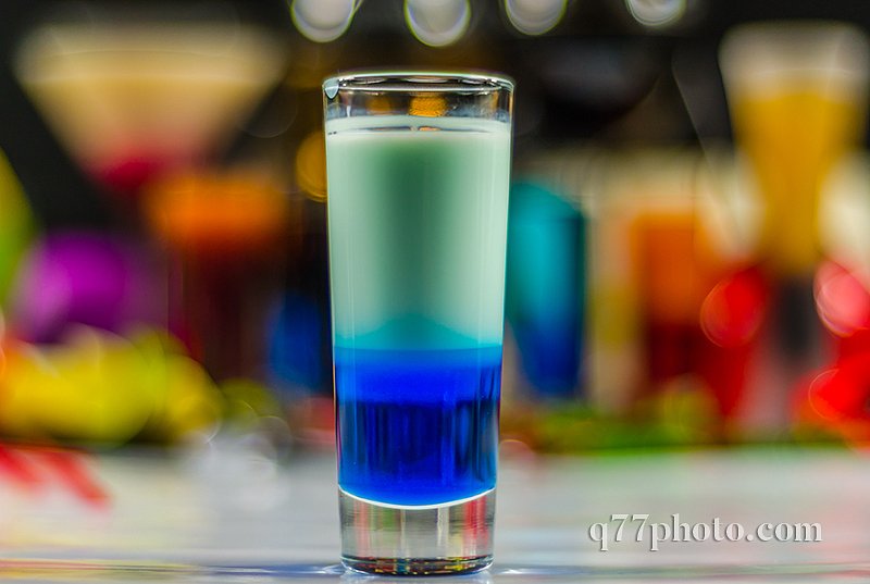colored drink in glass for shots, a combination of white with bl