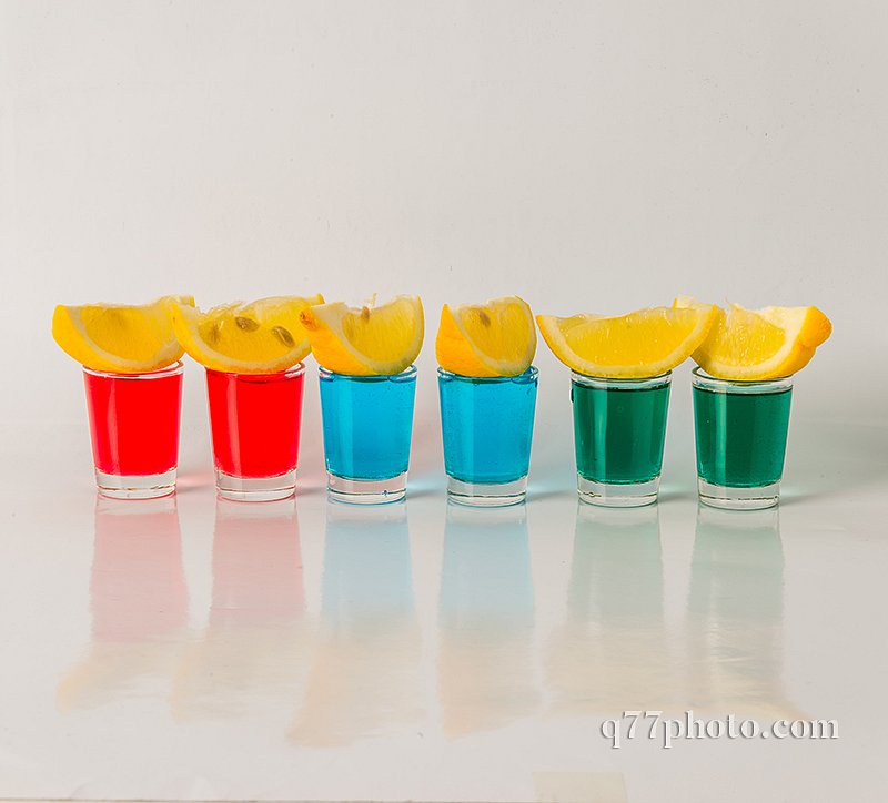 Glasses with blue, green and red kamikaze, glamorous drinks, mix