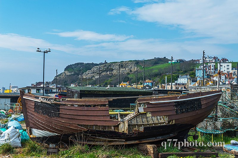 old wooden destroyed boat in a fishing port, on the shore, again